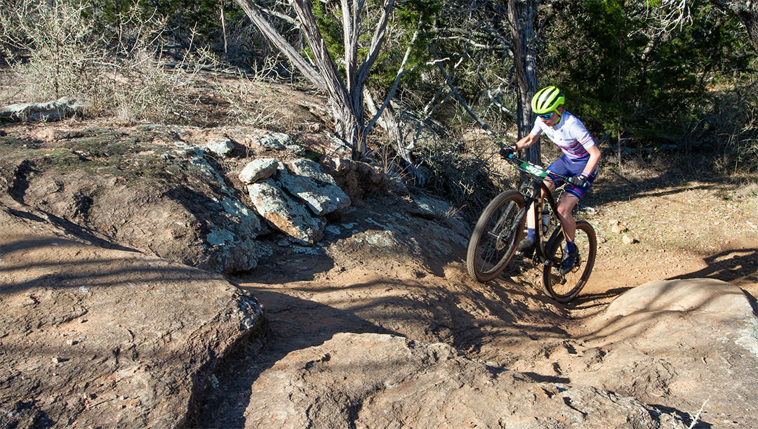 Texas High School student athlete riding up rocks at Reveille Peak Ranch